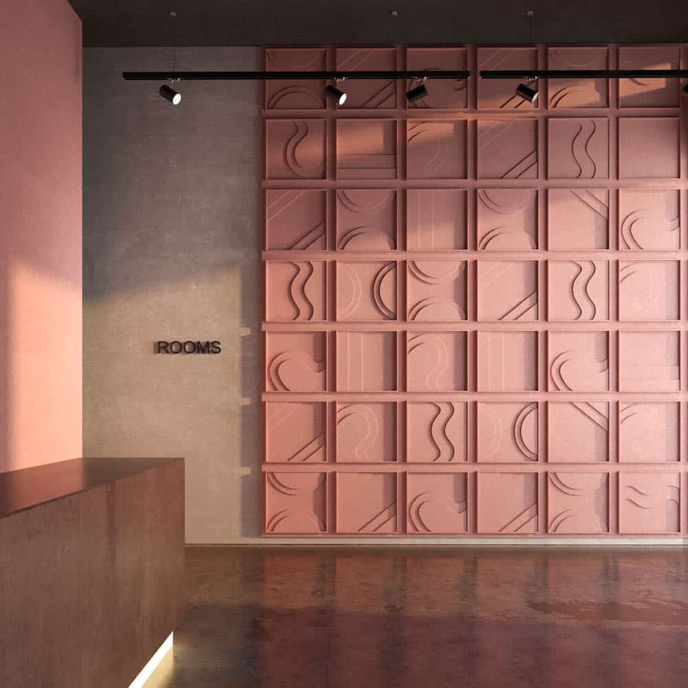 Panel acústico modular en tono rosa con relieves geométricos en pasillo de hotel – acabado decorativo para zonas de circulación